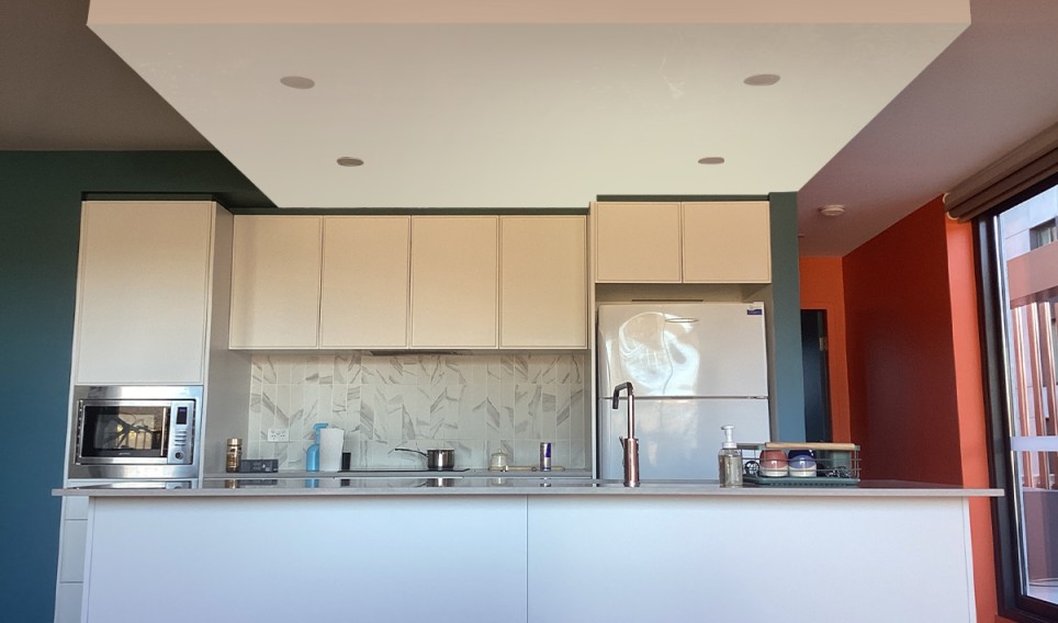 Modern kitchen with sleek cabinetry, stainless steel appliances, and a neutral colour palette, showcasing a fresh and inviting space ideal for residential repainting in Queanbeyan.