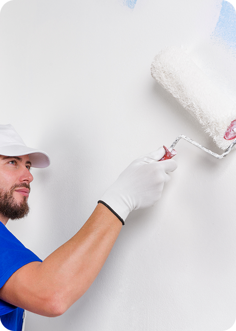 Painter applying fresh paint to a wall with a roller, showcasing skilled craftsmanship and attention to detail, relevant to C&C Painting Group's commitment to quality services in Canberra.