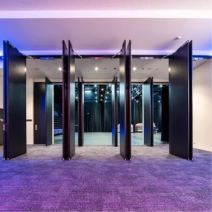 Interior view of a modern commercial space with retractable partition doors, showcasing a versatile design suitable for government and corporate environments.