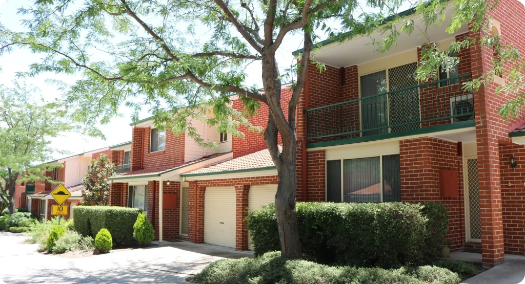 Strata residential buildings with brick facades and green landscaping, showcasing C&C Painting Group's focus on high-quality painting solutions for strata properties in Canberra.