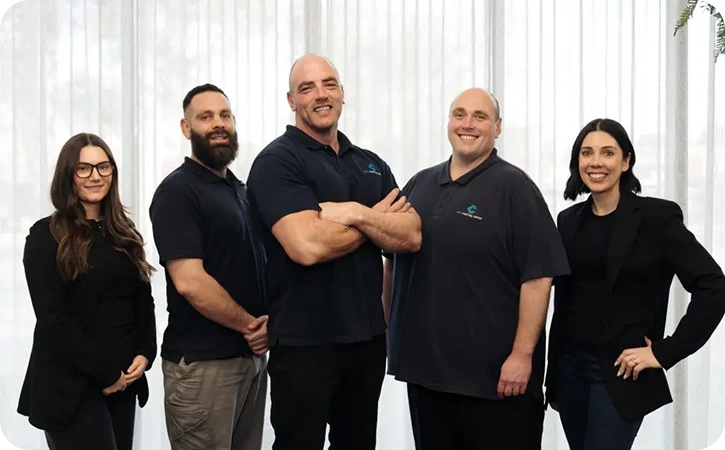 Team of professional painters from C&C Painting Group, showcasing commitment to quality service and customer satisfaction in a well-lit indoor setting.