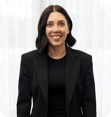 Tanya Chamberlain, Co-Owner & Director of Finance & Strategy at C&C Painting Group, smiling in a professional black blazer against a light backdrop.