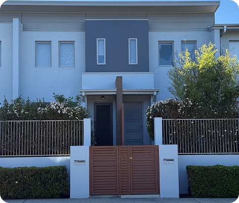 Modern strata property with a grey accent wall, front gate, and well-maintained landscaping, highlighting professional painting and maintenance services by C&C Painting Group.