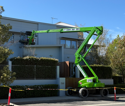 Cherry picker lifting workers for painting maintenance on a strata property, showcasing proactive asset management by C&C Painting Group.