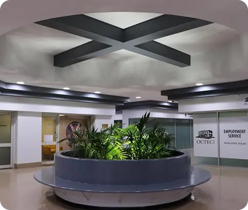 Modern commercial interior with circular planter, greenery, and contemporary ceiling design, reflecting C&C Painting Group's focus on high-quality finishes in professional environments.