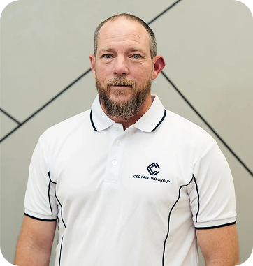 Team member from C&C Painting Group in a branded polo shirt, showcasing professional appearance and commitment to quality painting services.