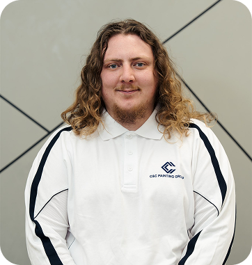 Team Leader at C&C Painting Group, wearing branded uniform, smiling against a modern background.