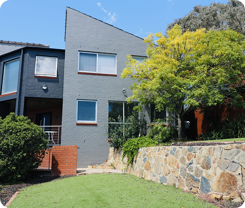 Modern residential home in Canberra showcasing high-quality exterior paint finish and well-maintained landscaping, highlighting C&C Painting Group's commitment to quality workmanship and transformation services.