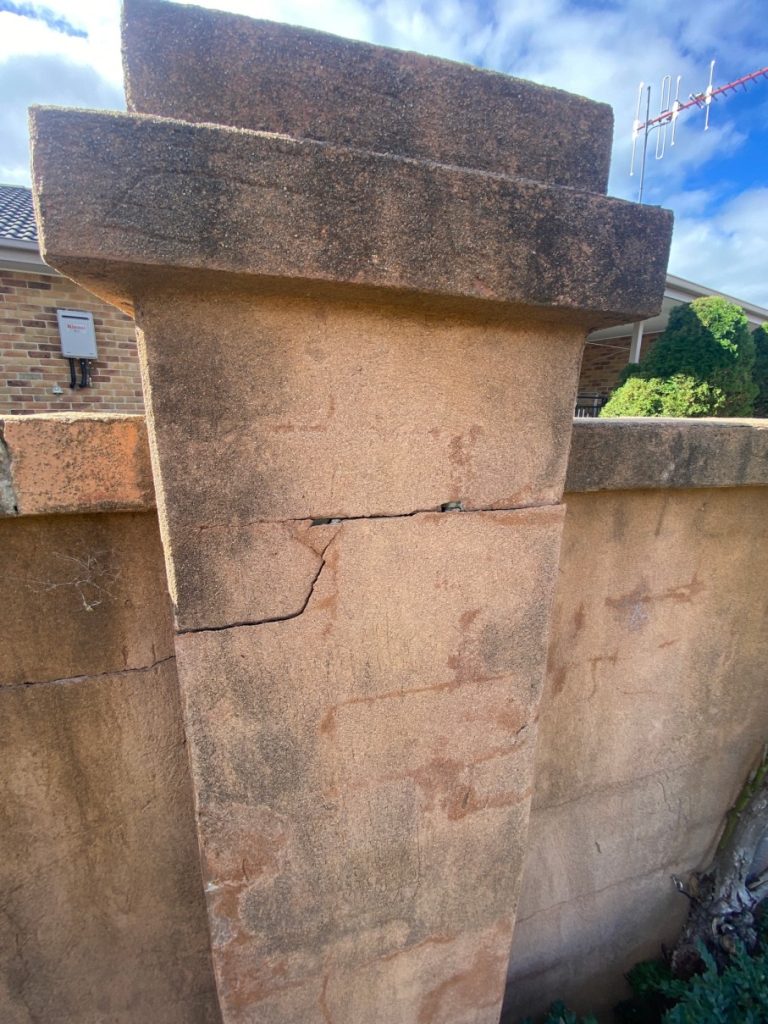 Cracked stone pillar indicating the need for repair, highlighting C&C Painting Group's property restoration services in Canberra.