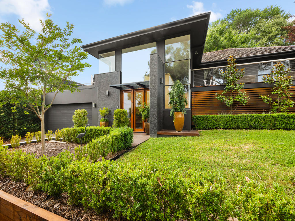 Modern residential home exterior in Deakin, featuring sleek architecture, landscaped garden, and premium finishes, showcasing C&C Painting Group's quality work in Queanbeyan.