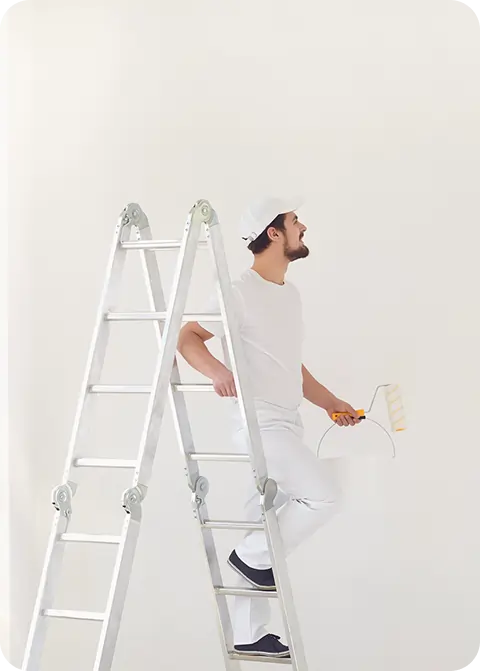 professional painter wearing a white uniform holding a roller