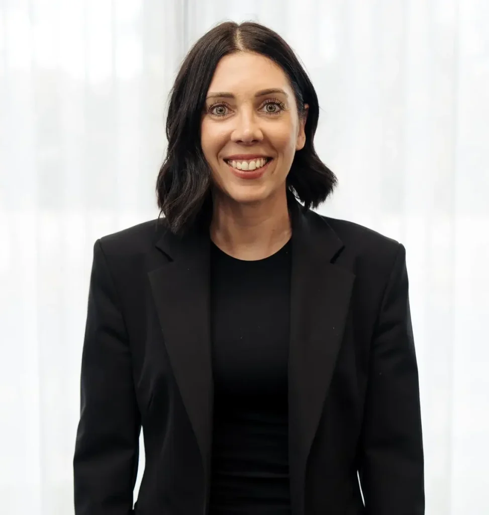 Tanya Chamberlain, Co-Owner and Director of C&C Painting Group, smiling in a black blazer against a light backdrop, emphasizing her leadership role in business operations and client satisfaction.